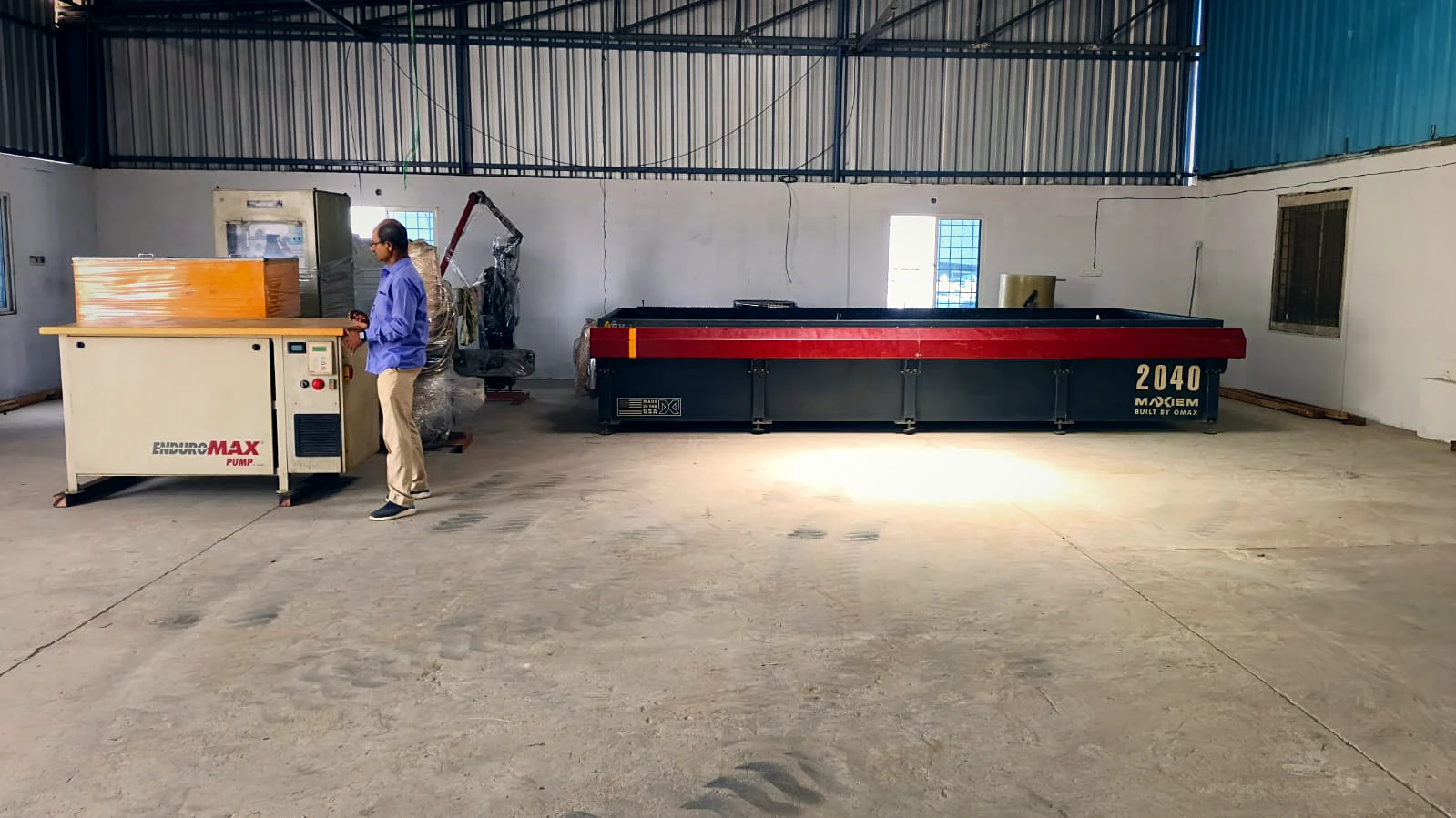 Our MAXIEM 2040 abrasive waterjet and high-pressure pump on the shop floor
